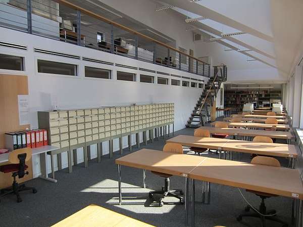 Reading room of Evangelisches Zentralarchiv in Berlin (Evangelical Central Archives in Berlin) Room with tables, seats, book shelves and file cabinets