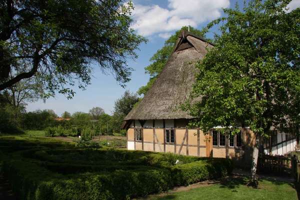 timbered farmhouse of a small farmer with a thatched roof