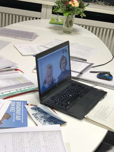 Laptop with open Skype window on the conference table of Beyond History